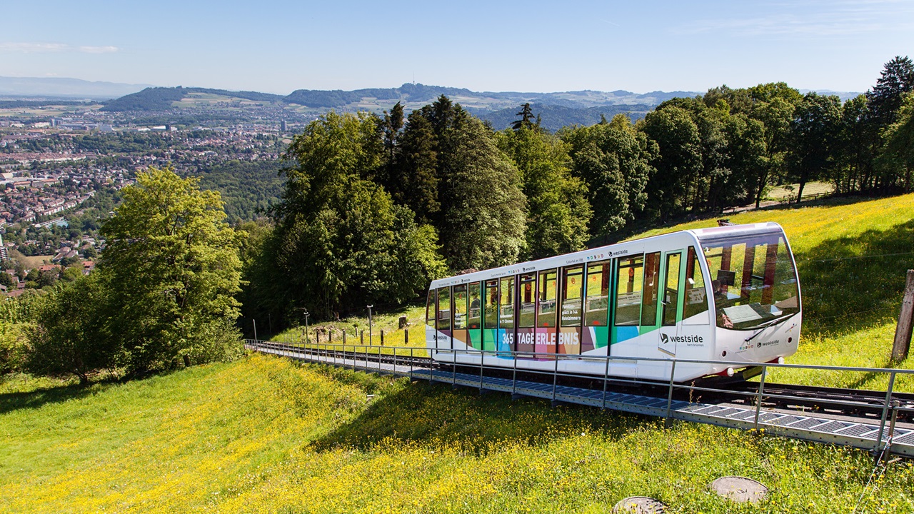 The Gurten funicular is wrapped in a westside poster. 