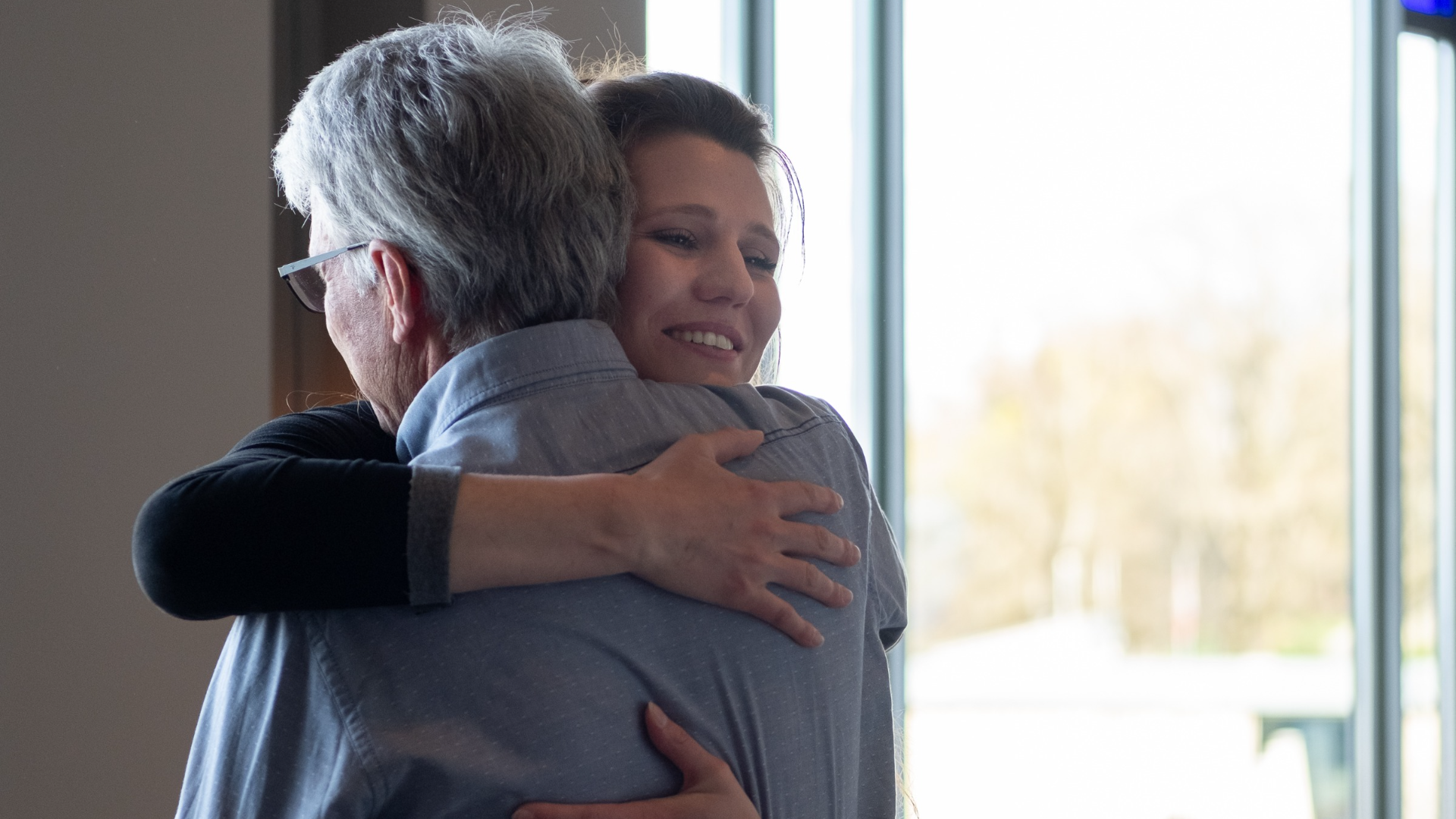 Daughter happily hugs her father