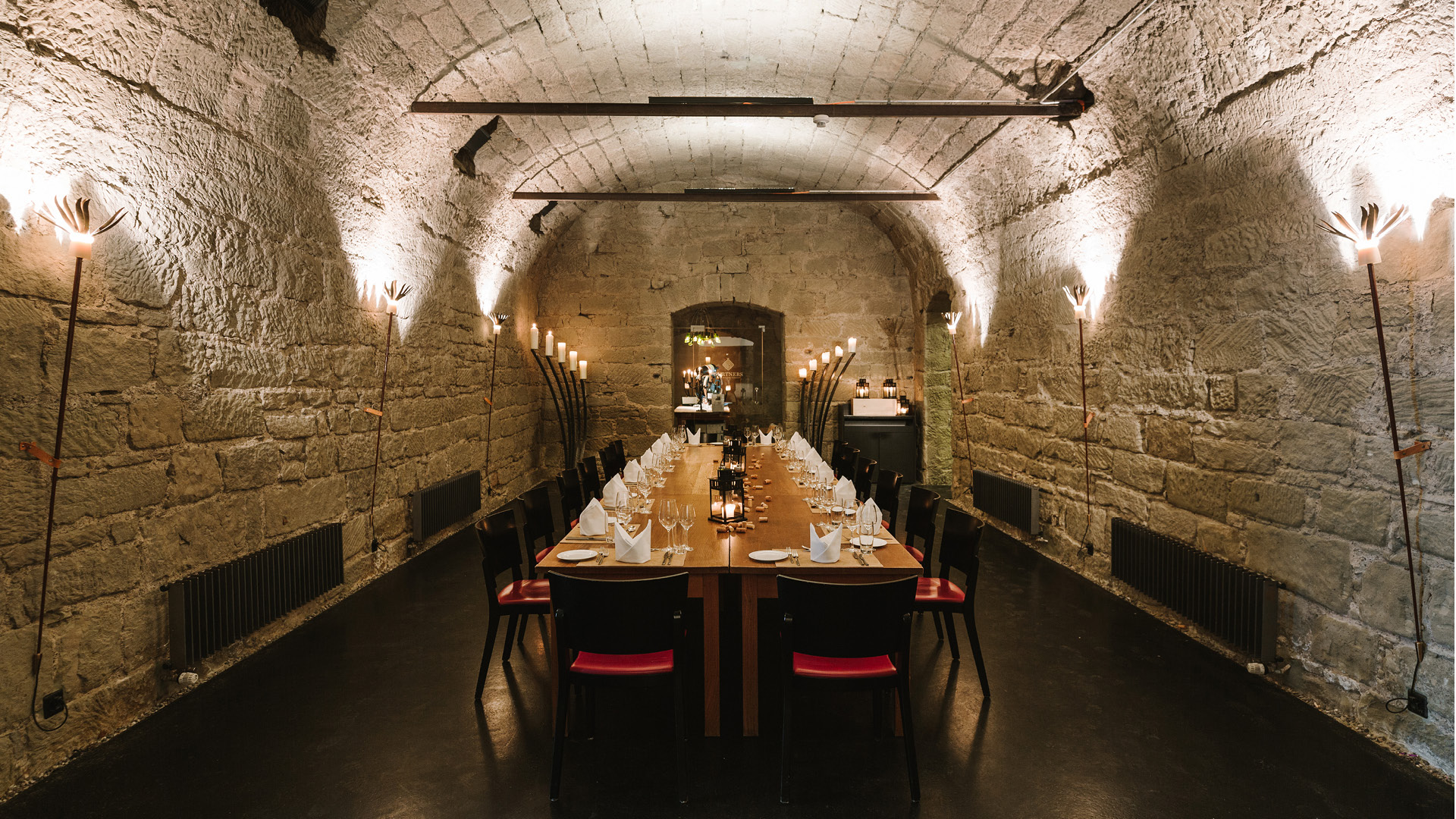 Festively laid boardroom table in the vaulted cellar