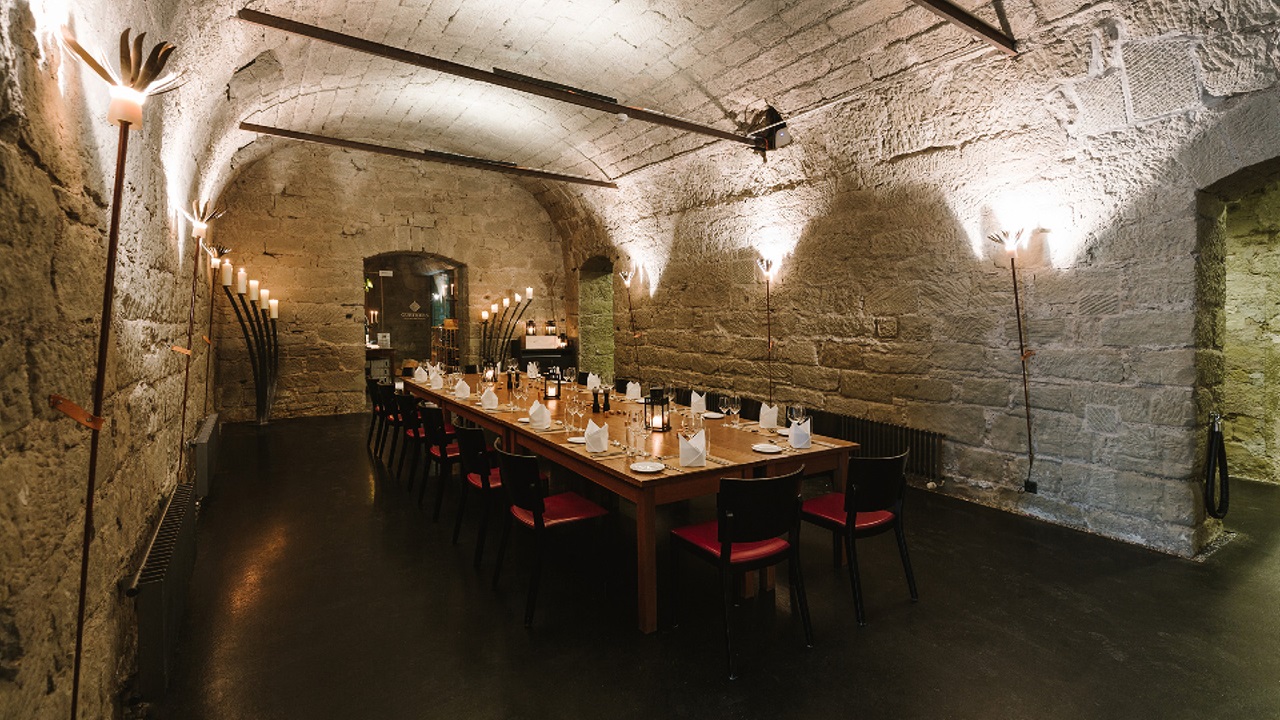 Illuminated vaulted cellar with festively laid table