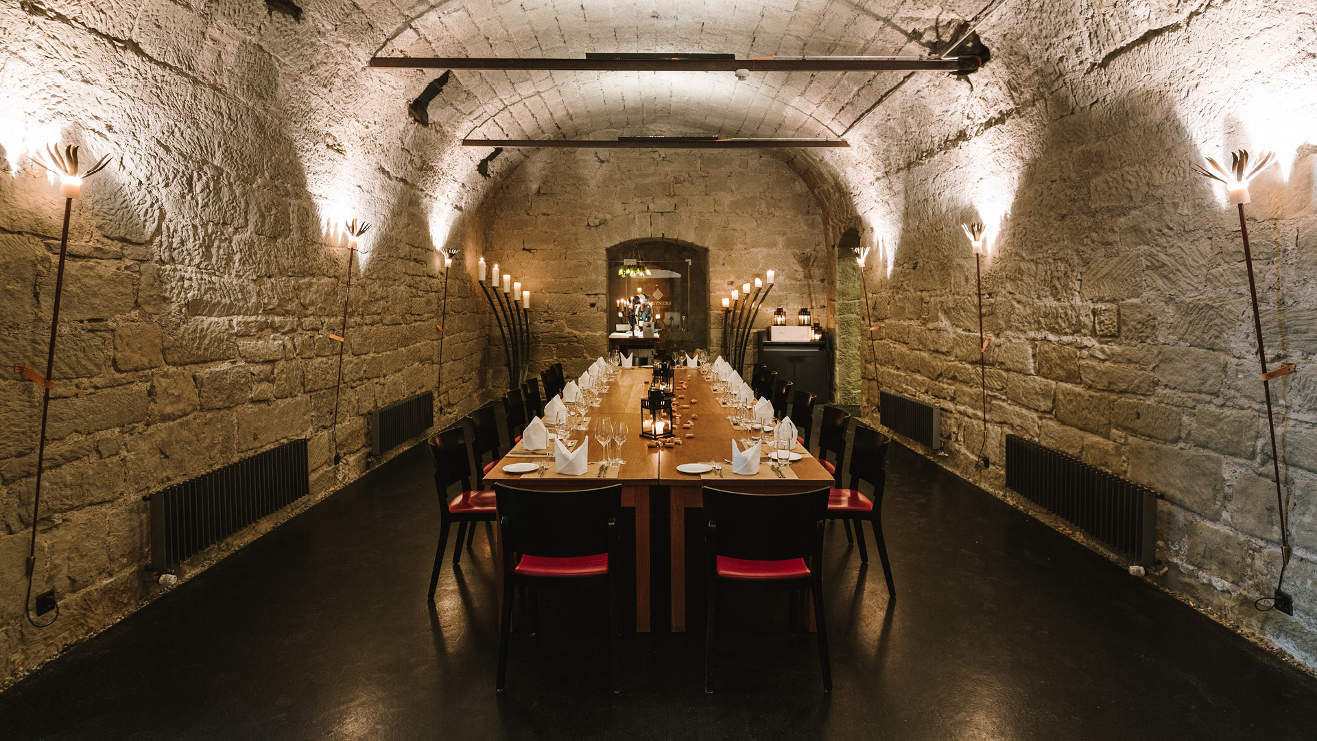 Set and lit boardroom table in the vaulted cellar