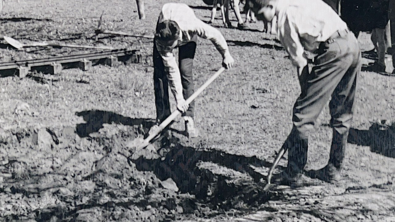 Men shovel space for the tracks.