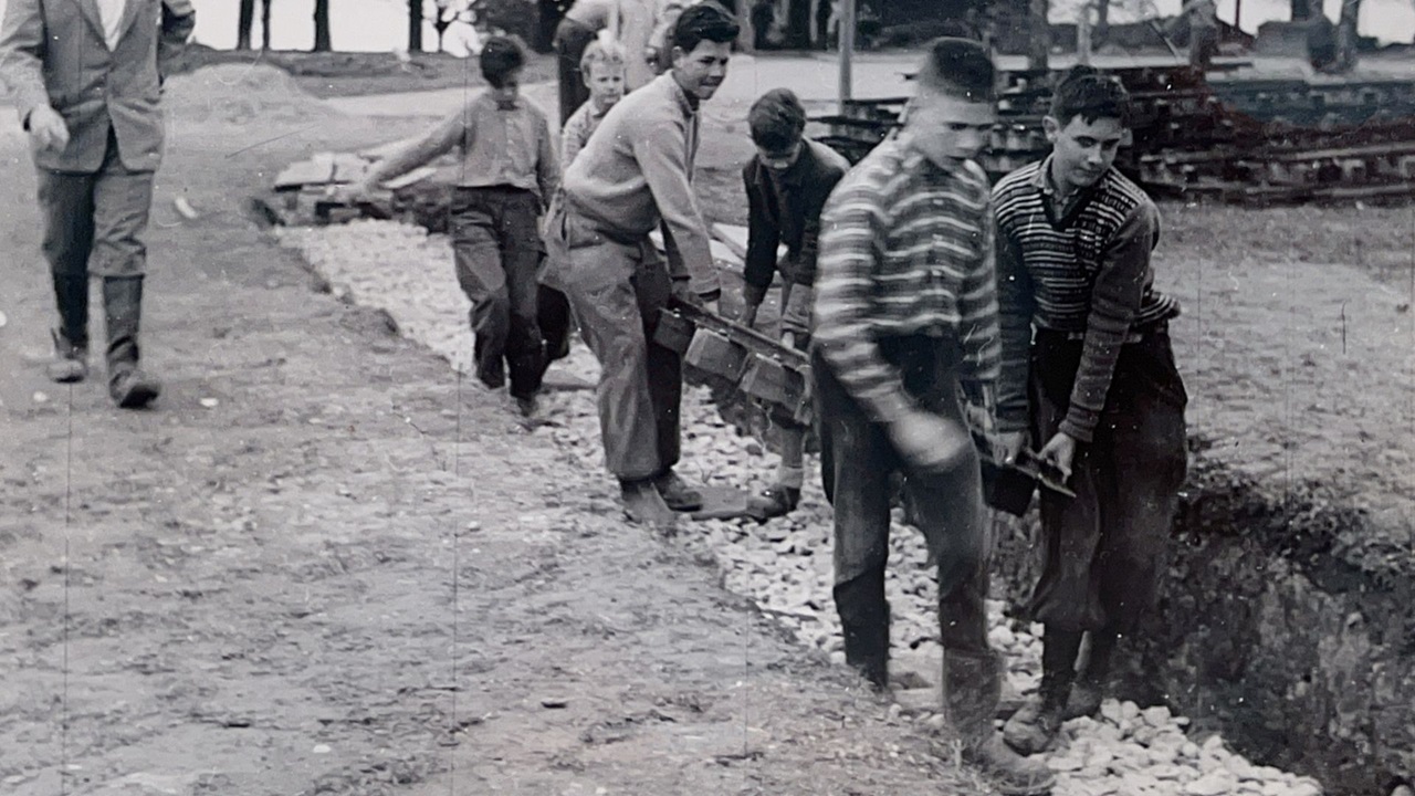  The men are transporting the tracks.  