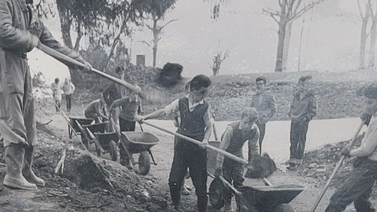 The men and the boys are packing away the earth.