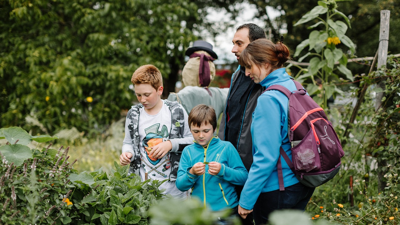 A family in the Gurten garden marveling at nature