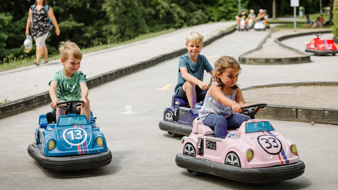 Young children playing with the kids cars