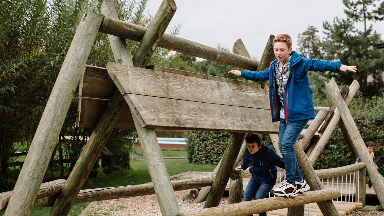 Two children playing and racing on the climbing frame