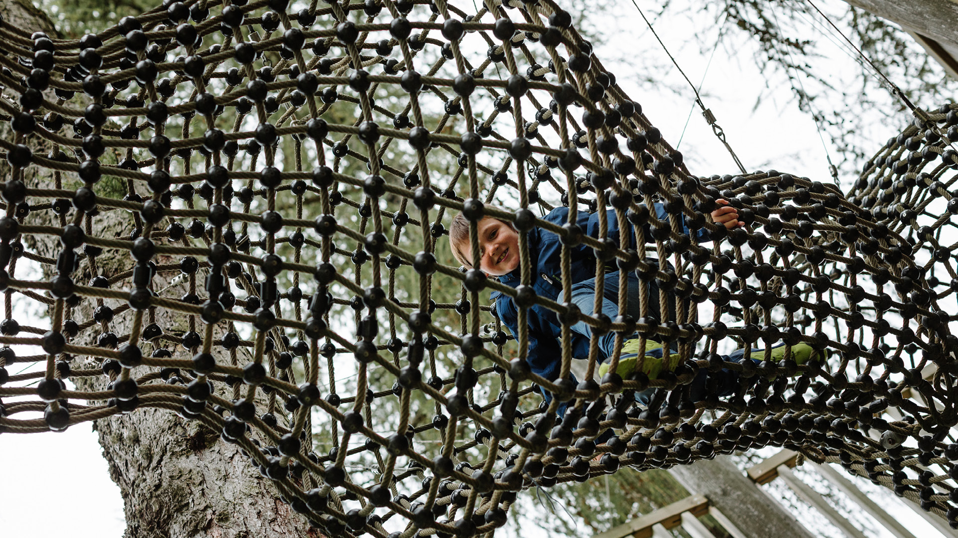 A child playing on the climbing net