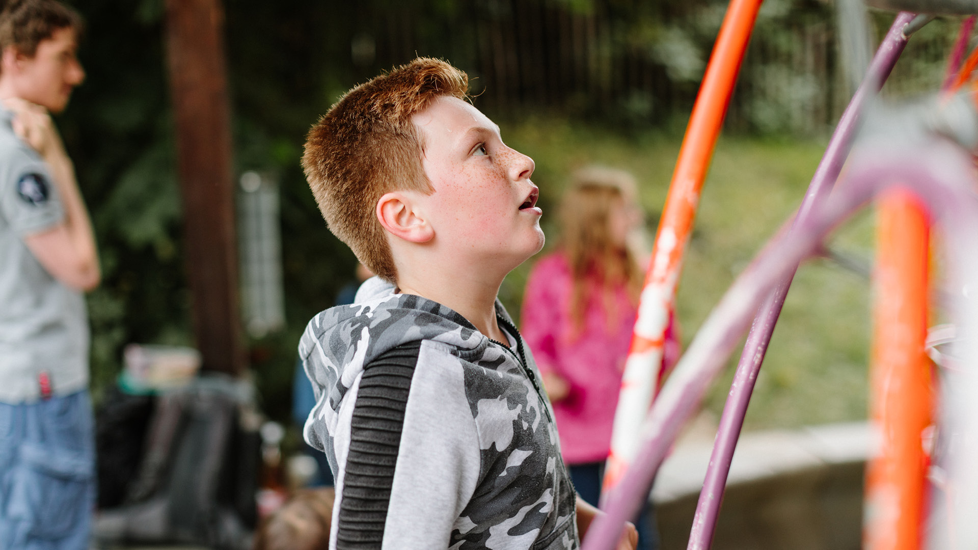 A child following the ball at the playground with their mouth open