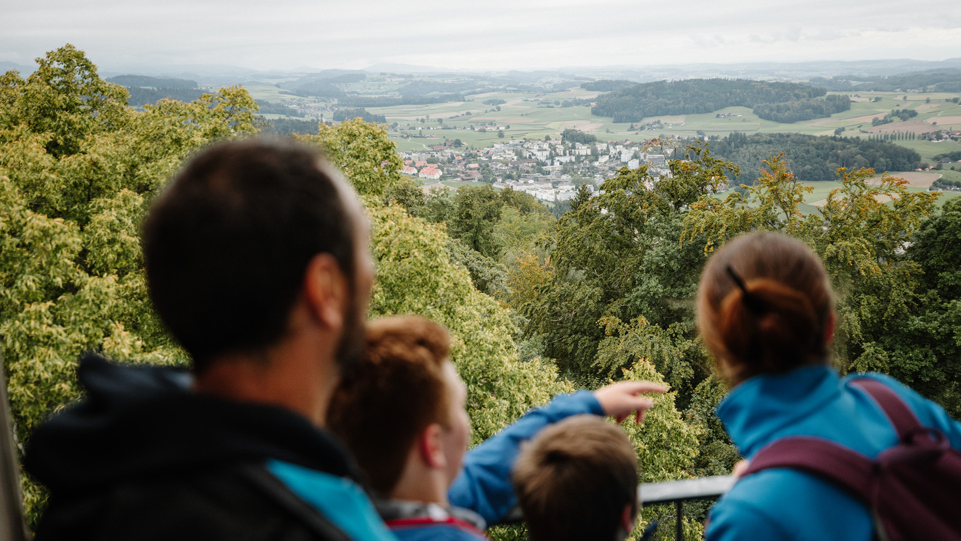 A family with two children taking in the view of the surrounding area from the observation tower.