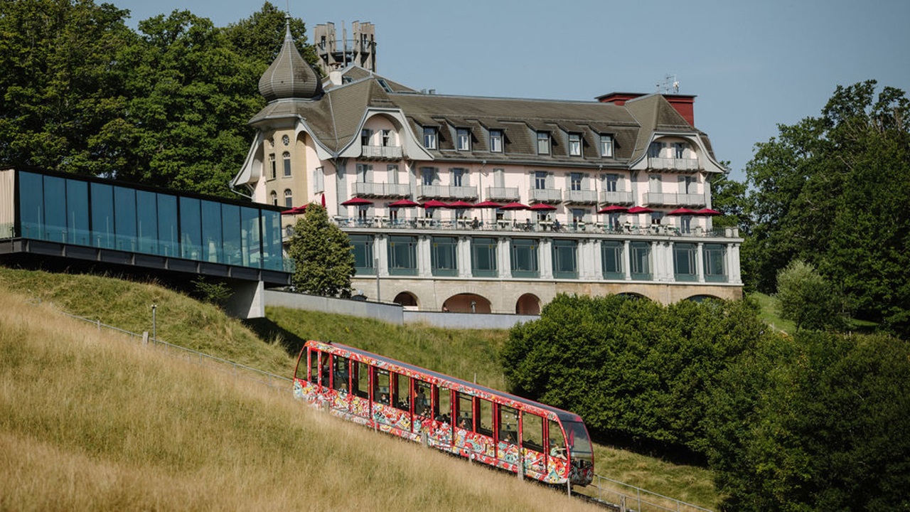 The red funicular travels down to the valley.