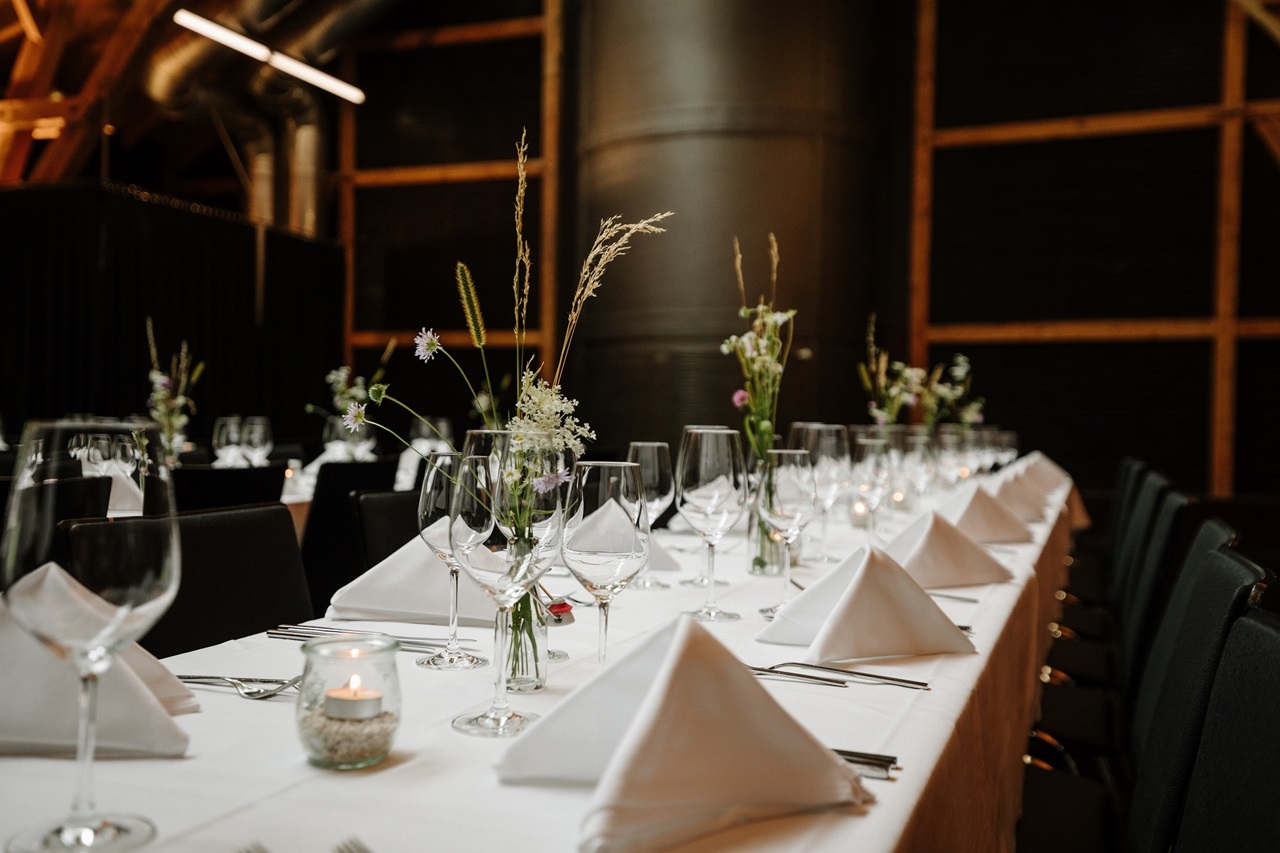 The Kulturschür event venue festively decorated with white tablecloths and napkins