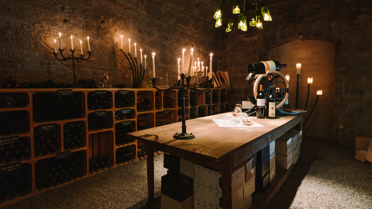 Wine cellar with wooden crates by candlelight