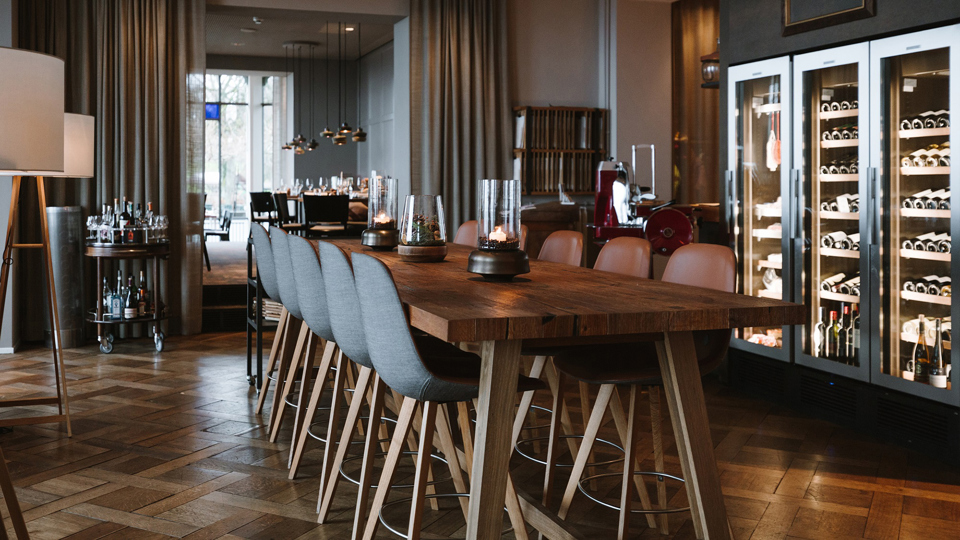 Une grande table en bois au centre du restaurant Gurtners