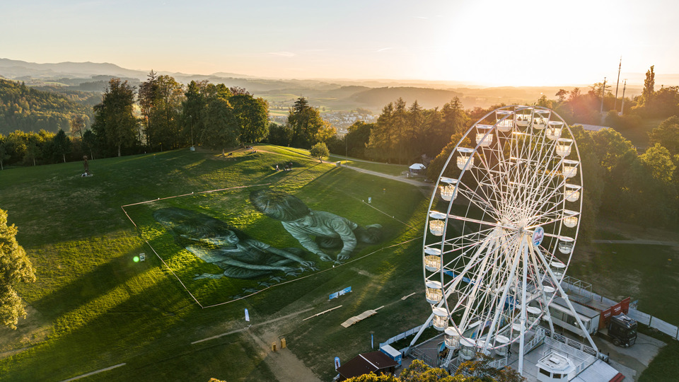 Saype's ephemeral artwork on Gurten seen from above.