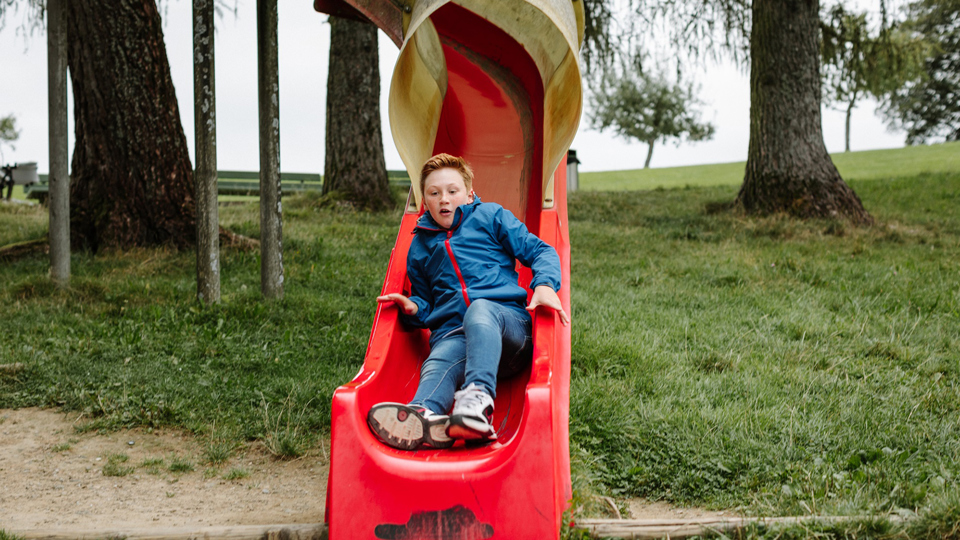 A child shooting down the long slide