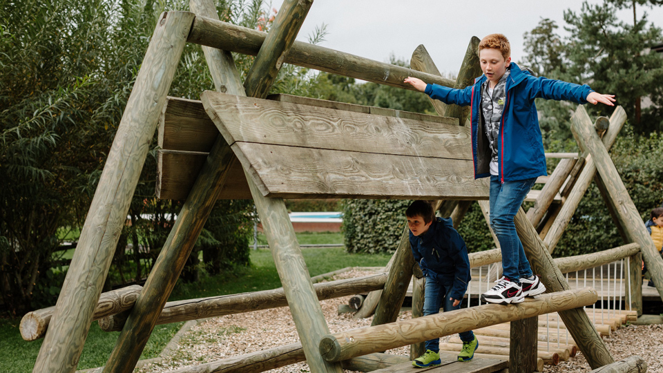 A child balancing above the climbing frame