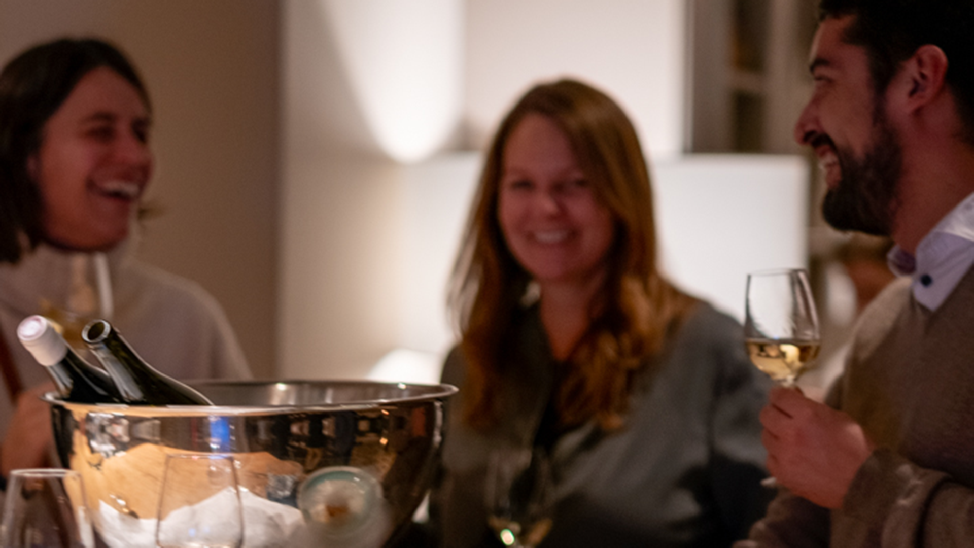 Three friends are tasting white wine together on Gurtner's wine tour