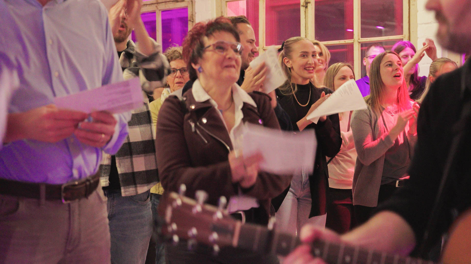 Singing choir with guitarist