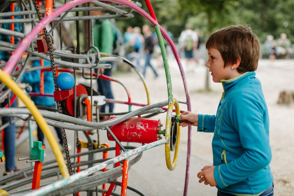 A child playing with the ball run on the play area