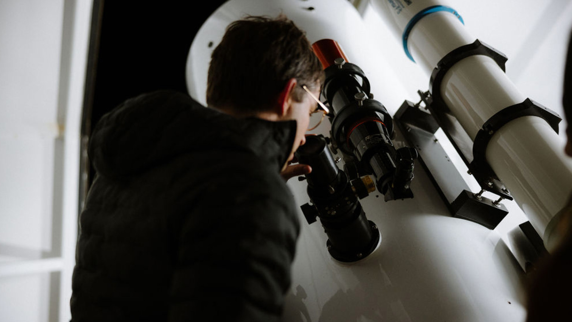 An expert looking through the telescope.