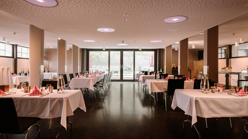 Le rez-de-chaussée du lieu événementiel Schüür avec des tables dressées pour le brunch Schüür.