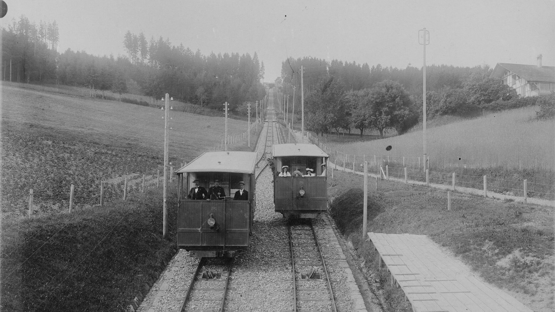 A black-and-white photograph of the old Gurtenbahn railway crossing each other.