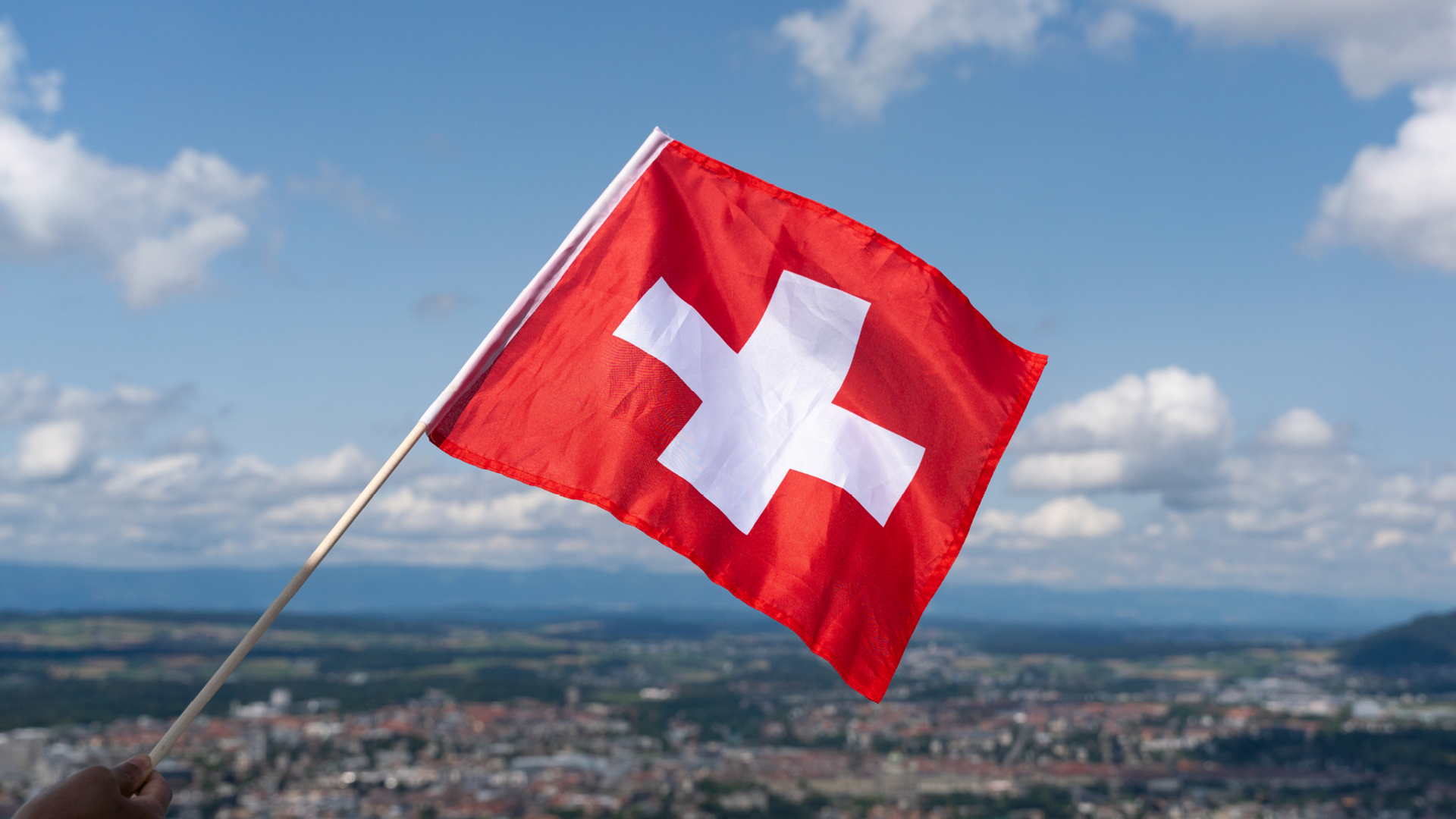 The Swiss flag in front of the city of Bern.